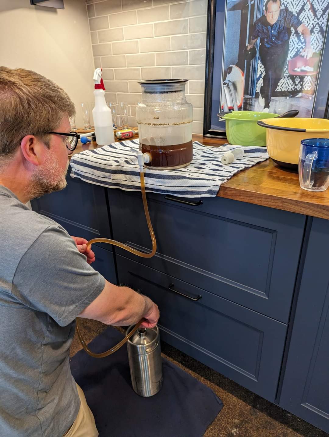 Photo of me putting a batch of beer into a one-gallon stainless steel keg