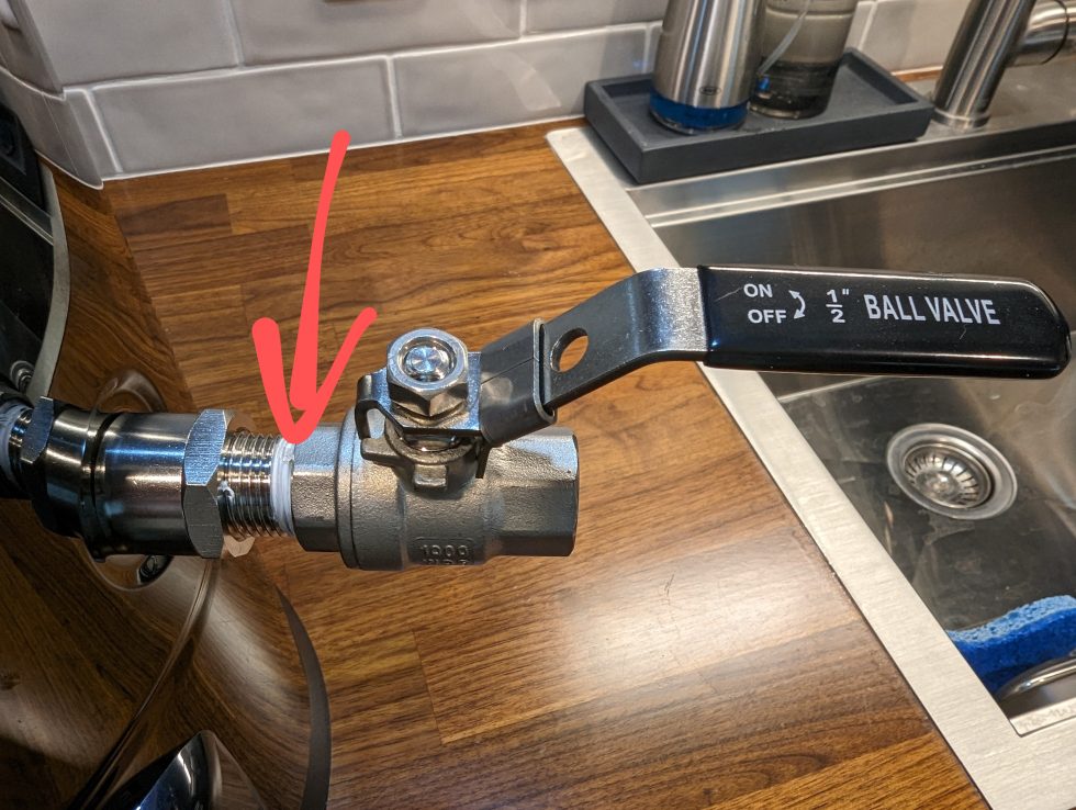 Photo of a Gigawort electric brewing kettle bulkhead with an arrow pointing to the location of a leak