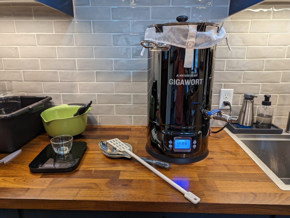 Photo of a Gigawort brew kettle, scale, and mash paddle on a counter
