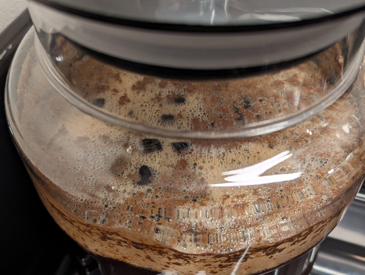 Close-up photo of bourbon-soaked oak cubes floating in fermenter