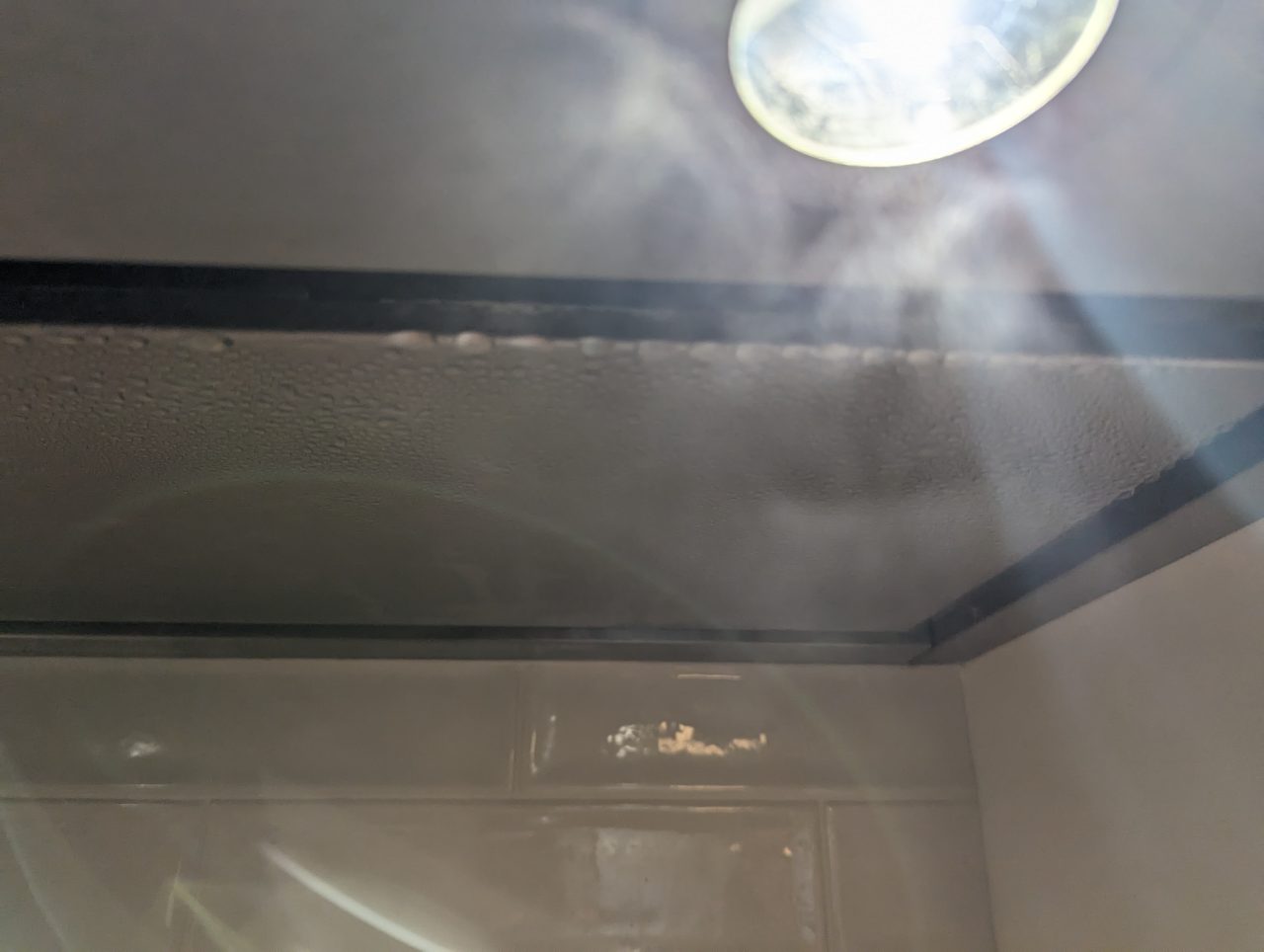 Photo of condensation on a stainless steel range hood