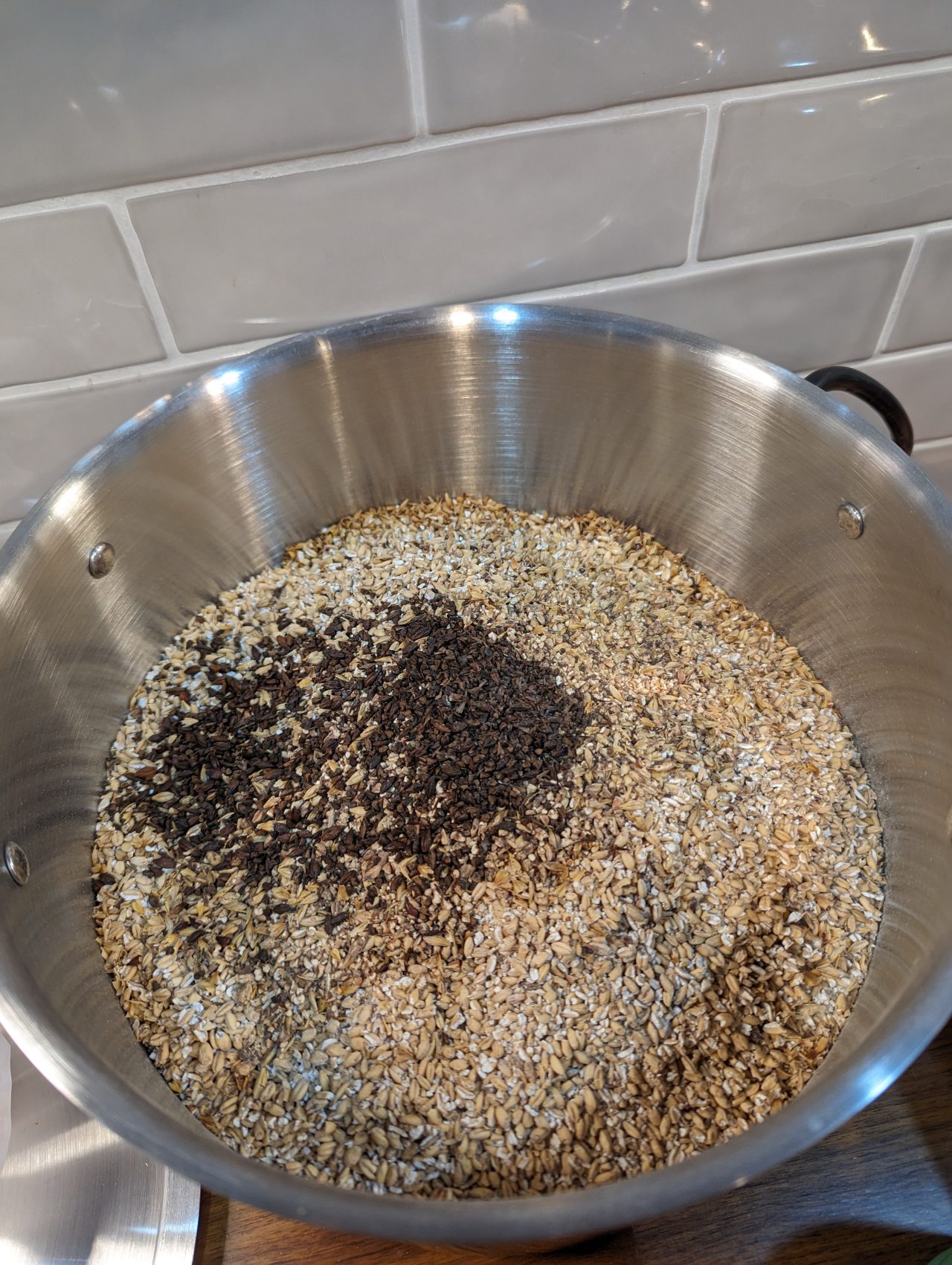 Photo of dry brewing grains in a stainless steel pot