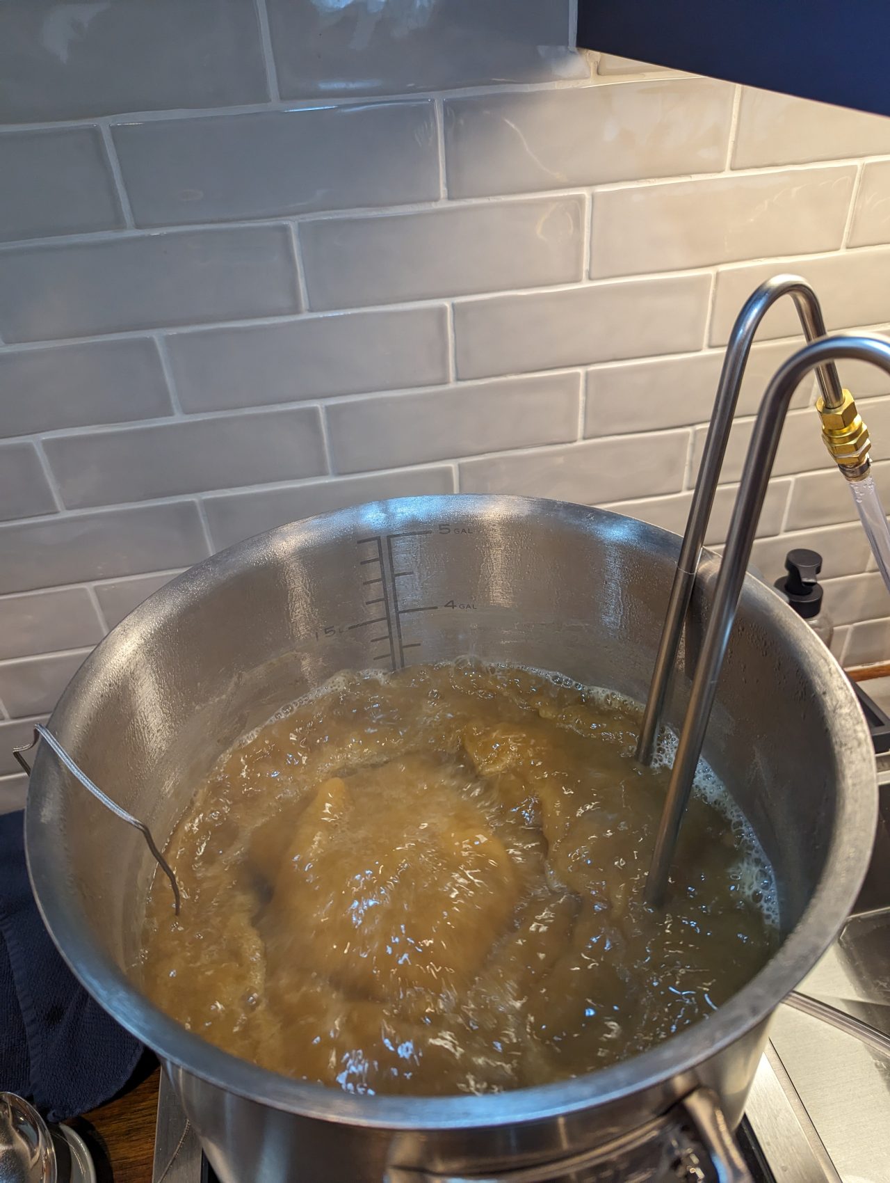 Photo of a stainless steel wort chiller in a stainless steel brewing kettle