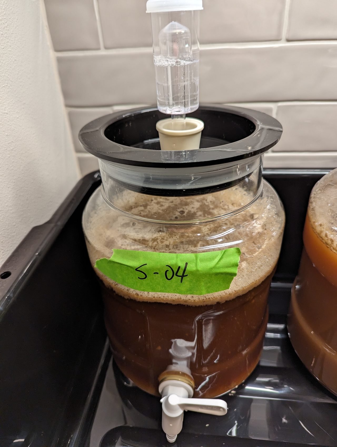 Photo of beer in a plastic fermenter with the label "S-04" on green masking tape