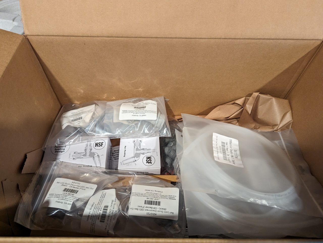 Photo of a box of kegerator parts including hoses and tap faucets