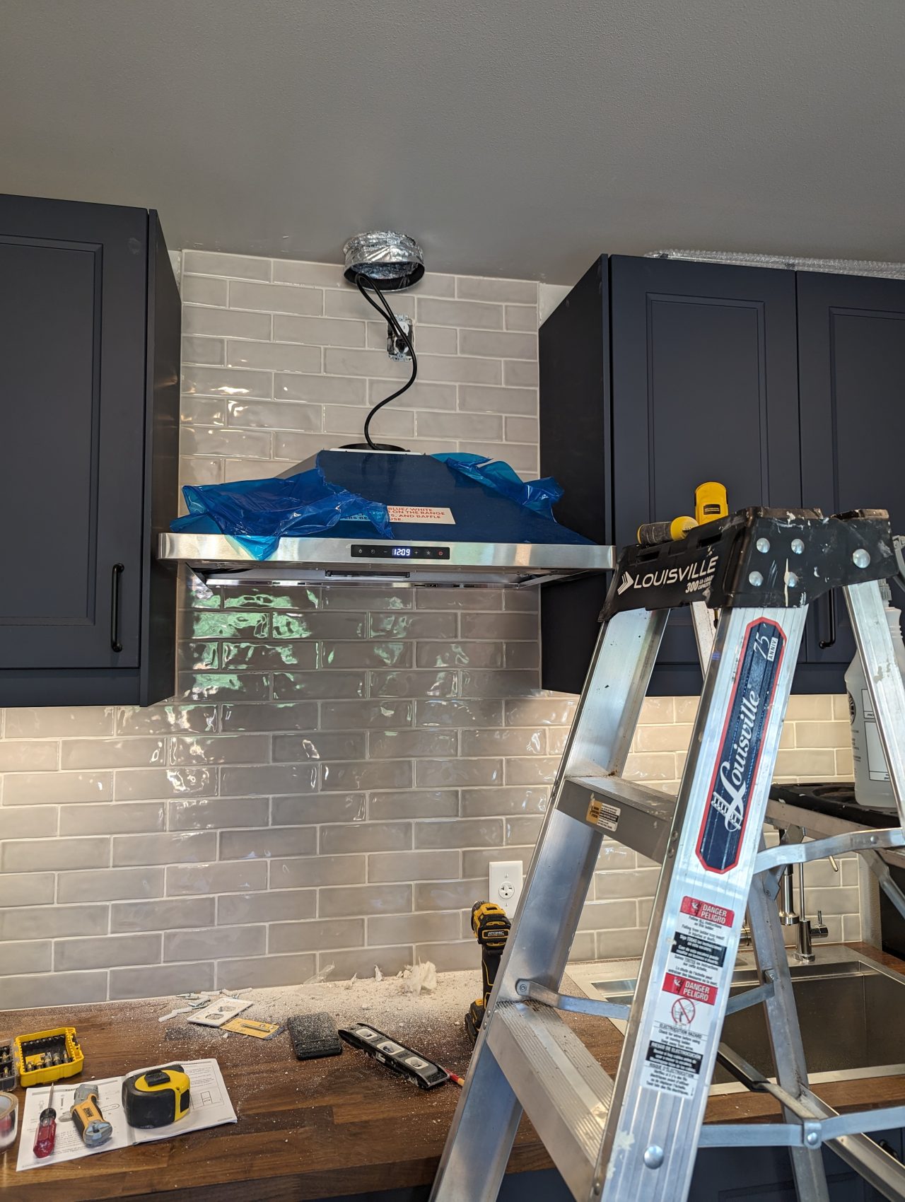 Photo of range hood being installed