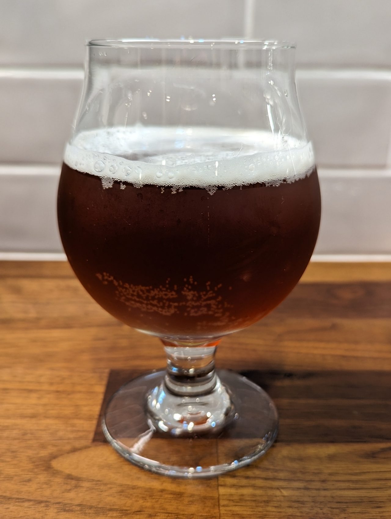 Photo of a homebrew Christmas ale in a chalice-style glass, made with Fermentis S-04 yeast