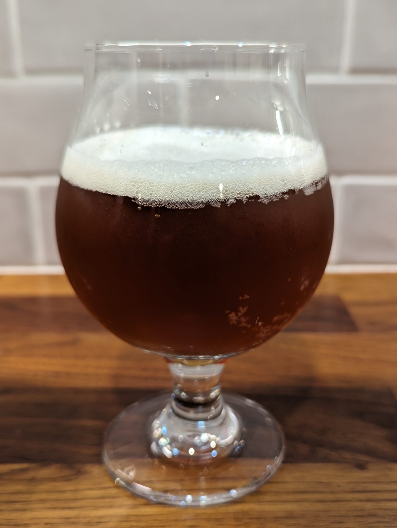 Photo of a homebrew Christmas ale in a chalice-style glass, made with Fermentis T-58 yeast