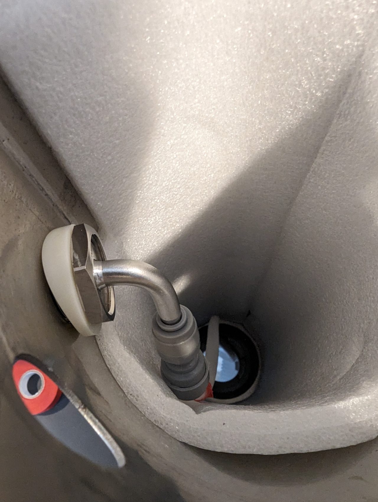 Photo of the inside of a beer tower showing a shank nut and collar tightened against the tower