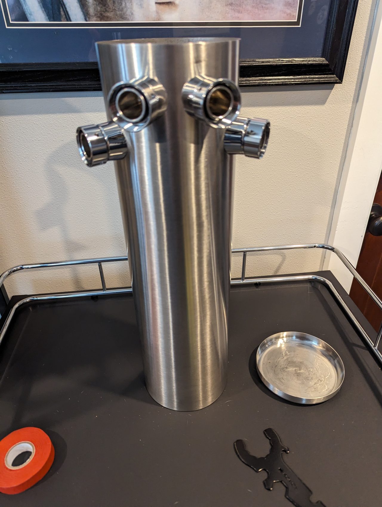 Photo of the outside of a beer tower with four shanks installed