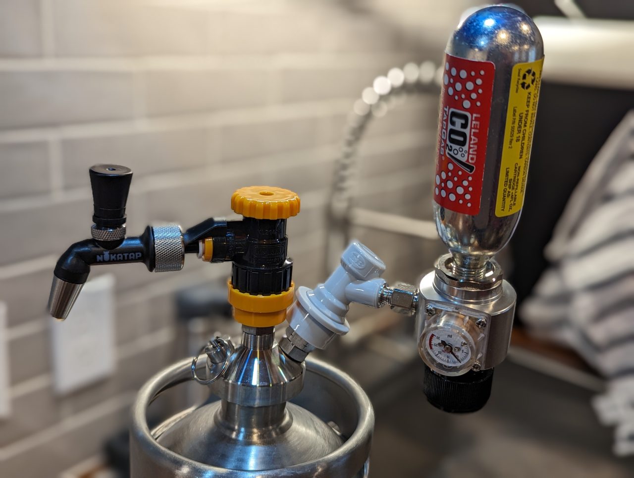 Photo of a Nukatap mini beer faucet and a Duotight flow control quick disconnect on a 1-gallon mini key with a 74g CO2 cartridge